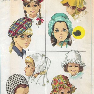 May include: A vintage Simplicity sewing pattern for children's hats. The pattern includes six different hat styles: a plaid beret, a yellow flower-shaped hat, a white bonnet, a checkered bonnet, a blue bonnet, and a floral print sun hat. The pattern is for size 21 inches.