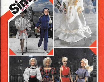 May include: A Simplicity sewing pattern for doll clothes, featuring a bride, a woman in a blue tracksuit, a woman in a plaid dress, a woman in a white blouse and black pants, a woman in a plaid dress, a woman in a red dress, and a woman in a blue dress. The pattern number is 6097.