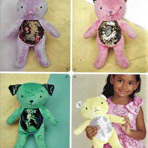 May include: A sewing pattern for making four plush toys. The pattern includes instructions for making a purple, pink, green, and yellow plush toy. Each toy has a sequin belly that changes color when flipped. The pattern is from Simplicity and is size one.