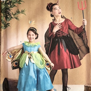 May include: Simplicity Costumes pattern featuring two children in Halloween costumes. One child wears a blue and green peacock costume, and the other wears a red devil costume with a pitchfork. The pattern includes the text "COSTUMES".