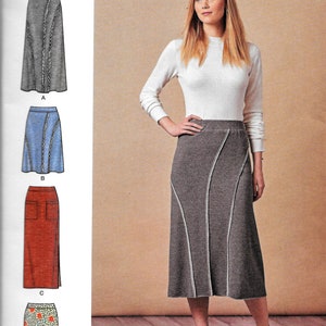 May include: A sewing pattern for a skirt with four different styles. The pattern is called Simplicity 8745 and is easy to sew. The skirt styles include a gray skirt with a white trim, a blue skirt with a white trim, a red skirt with a white trim, and a floral skirt with a white trim.