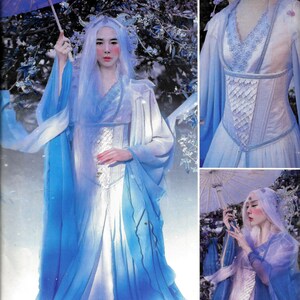 May include: Simplicity sewing pattern R10290, size US 6-14, for a white and blue fantasy costume with a corset, long sleeves, and a flowing skirt. The model is wearing a white wig and holding a blue and white umbrella.