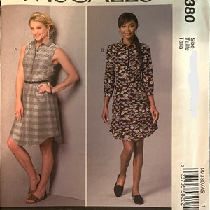 May include: A sewing pattern for a dress with two different styles. The first style is a sleeveless dress with a plaid pattern. The second style is a long-sleeved dress with a floral pattern. The pattern is by McCall's and is for size 7380.