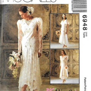 May include: McCall's sewing pattern with three bridal gown designs. The main image displays a long-sleeved, lace-detailed wedding dress with a cascading skirt. The pattern number is 6948, with the Alicyn Exclusives logo.