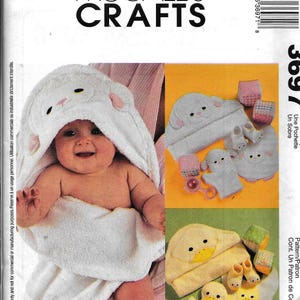 May include: A sewing pattern for a hooded towel, a hat, and mittens for a baby. The pattern includes a lamb and a duck design. The pattern is from McCall's Crafts and is number 3697.