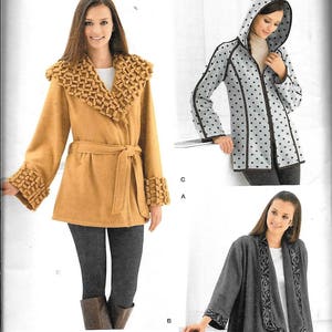 May include: A sewing pattern for three different jackets. The first jacket is a brown wrap jacket with a ruffled collar and cuffs. The second jacket is a gray hooded jacket with black polka dots. The third jacket is a gray wrap jacket with a black floral trim. The pattern is for sizes XS to XL.