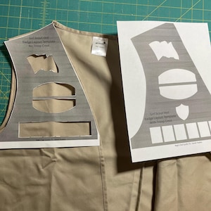 May include: Two printable templates for Girl Scout vest badge layouts. One template includes a space for a troop crest, the other does not.