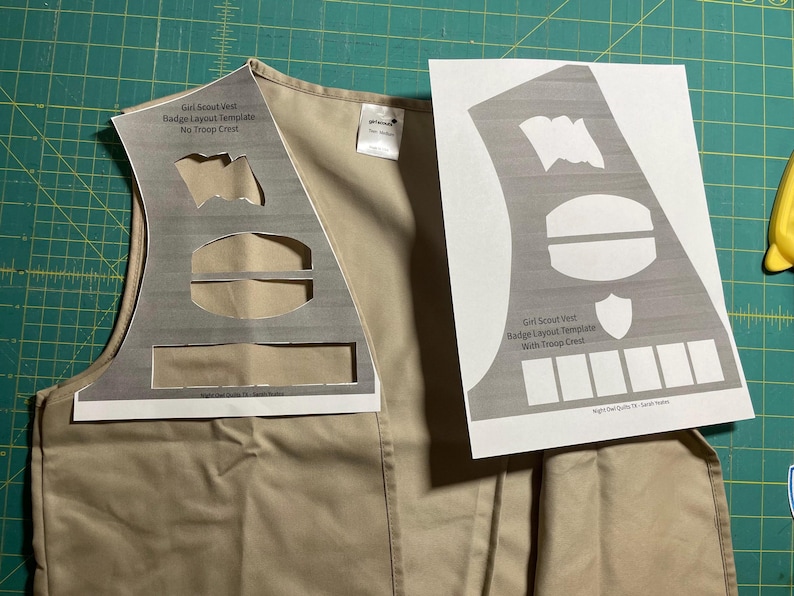 May include: Two printable templates for Girl Scout vest badge layouts. One template includes a space for a troop crest, the other does not.