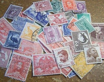 May include: A collection of vintage Australian postage stamps featuring various designs, including a kangaroo, a bird, and a map. The stamps are in different colors and sizes, and some have been used.