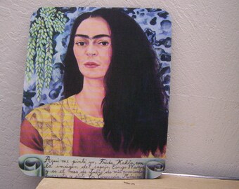 May include: A colorful painting of Frida Kahlo, a Mexican artist, with a quote in Spanish below the image. The quote reads "Aqui me pinté yo, Frida Kahlo, con la imagen del espejo, y es el mes de Julio de mil novecientos cuarenta y siete. En Coyoacán, México."