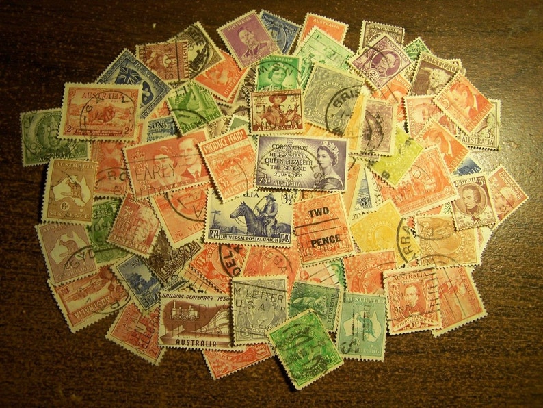 May include: A collection of vintage postage stamps in various colors, including red, green, blue, and orange. The stamps feature portraits, historical figures, and geographical designs. Some stamps have text such as "Australia" and "Two Pence".