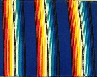 May include: A blue and white striped throw blanket with red, yellow, and turquoise accents. The blanket is woven with a traditional Mexican design.