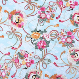 May include: A light blue fabric with a repeating pattern of stylized flowers, ribbons, and birds. The flowers are in shades of pink, orange, and white, with green leaves. The ribbons are in shades of red, orange, and green.