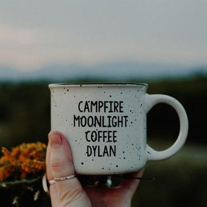 Ceramic coffee mug that says Campfire Moonlight Coffee Dylan.  White speckled 13oz campfire style mug. inspired by our love of Bob Dylan