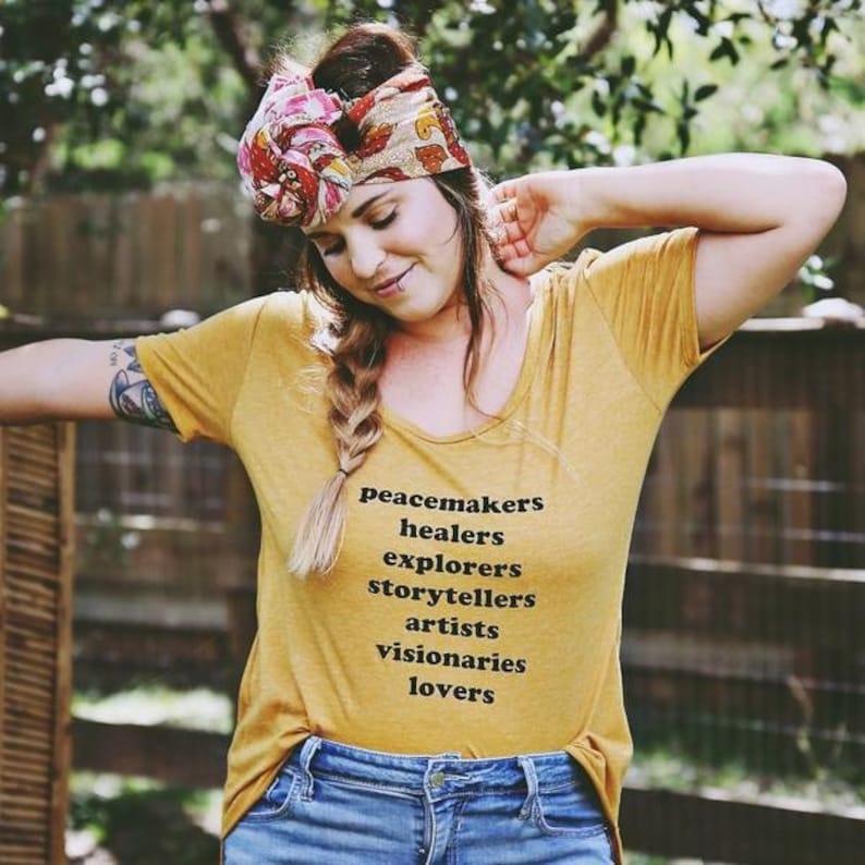 Flowy, soft mustard colored tshirt says "Peacemaker Healers Explorers Artists Visonaries Lovers" 
Printed with black ink. Perfect for any boho woman.