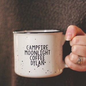 Ceramic coffee mug that says Campfire Moonlight Coffee Dylan.  White speckled 13oz campfire style mug. inspired by our love of Bob Dylan