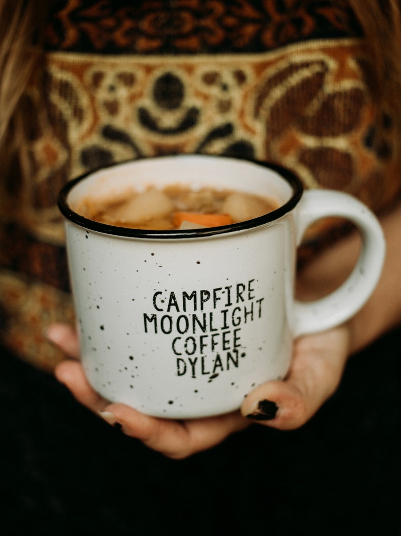 Ceramic coffee mug that says Campfire Moonlight Coffee Dylan.  White speckled 13oz campfire style mug. inspired by our love of Bob Dylan