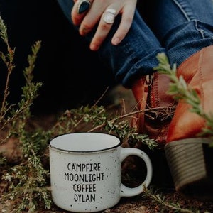 Ceramic coffee mug that says Campfire Moonlight Coffee Dylan.  White speckled 13oz campfire style mug. inspired by our love of Bob Dylan