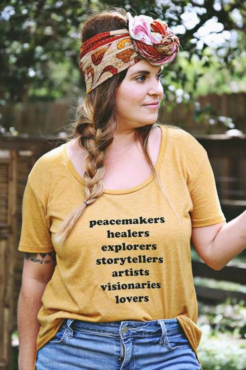 Flowy, soft mustard colored tshirt says "Peacemaker Healers Explorers Artists Visonaries Lovers" 
Printed with black ink. Perfect for any boho woman.