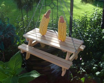 Picnic table squirrel feeder