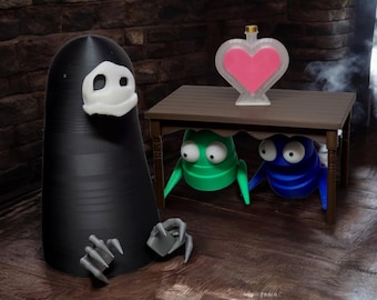 May include: A black figure with a white face and a pair of clawed hands stands in front of a wooden table. Under the table, two small figures, one green and one blue, peek out from under the table. A heart-shaped bottle with pink liquid sits on the table.