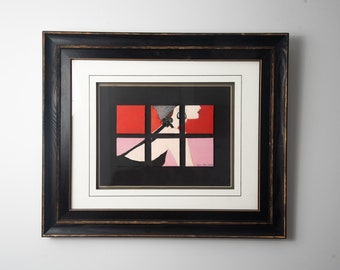 May include: Framed print of a woman's silhouette in a black dress, with red and pink geometric shapes behind her.
