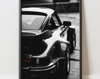 May include: Black and white framed print of a classic sports car. The image focuses on the rear of the car, showcasing its sleek lines and spoiler. The print has the text "APEXXPOSTERS" at the bottom.