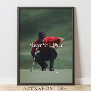 May include: A framed poster featuring a golfer in a red shirt and black cap crouching on a green golf course with a putter and ball. The text Master Your Mind is centred in white serif font. The bottom of the frame displays APEXXPOSTERS.