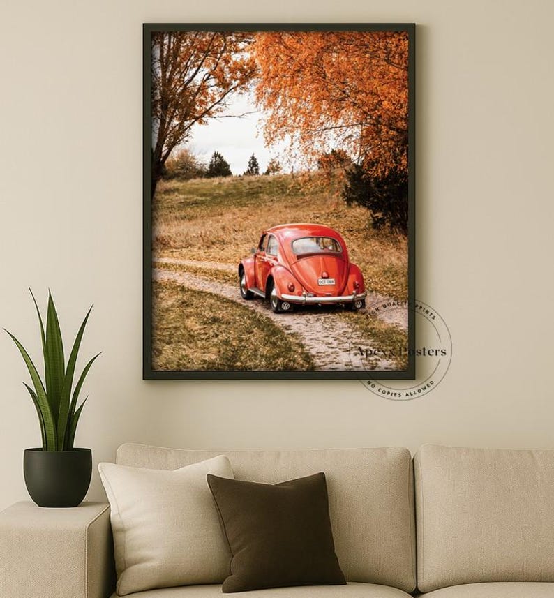 May include: A framed wall art print featuring a red vintage car parked on a dirt path surrounded by autumn trees with orange foliage. The print includes a circular watermark in the bottom right corner with the text Apexx Posters.