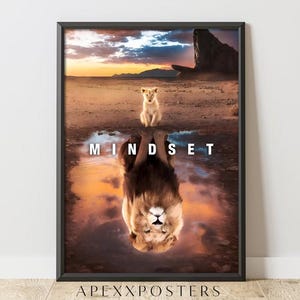 May include: Framed art print featuring a lion cub and its reflection, forming a mature lion, in a desert landscape. The word "MINDSET" is displayed across the reflection. The print has a black frame and the text "APEXXPOSTERS" at the bottom.