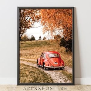 May include: A framed wall art print featuring a bright red vintage Volkswagen Beetle parked on a dirt path. The scene is set in an autumn landscape with golden-orange trees and dry grass. The text APEXXPOSTERS is printed at the bottom of the frame.