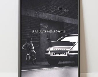 May include: A black and white framed wall art print featuring a child on a bicycle next to a parked sports car in front of a brick building. The text It All Starts With A Dream is centered above the car, and the license plate reads KGL 333.