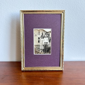 May include: A white ceramic mug with a black handle and the text "But First, Coffee" in a bold, black font. The mug is set against a neutral background, highlighting its simple design.