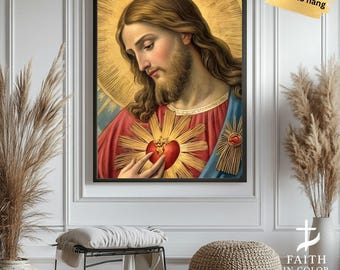 May include: Framed religious art print featuring a portrait of Jesus with long brown hair and a beard. He is wearing a red robe with blue accents and a golden halo. The image includes a heart with rays of light.