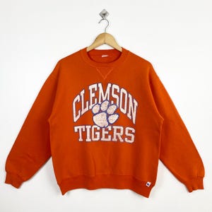 Sudadera de cuello redondo con el logo estampado de los Tigres de la Universidad de Clemson de la NCAA de los años 90, color naranja, para hombre (talla M)