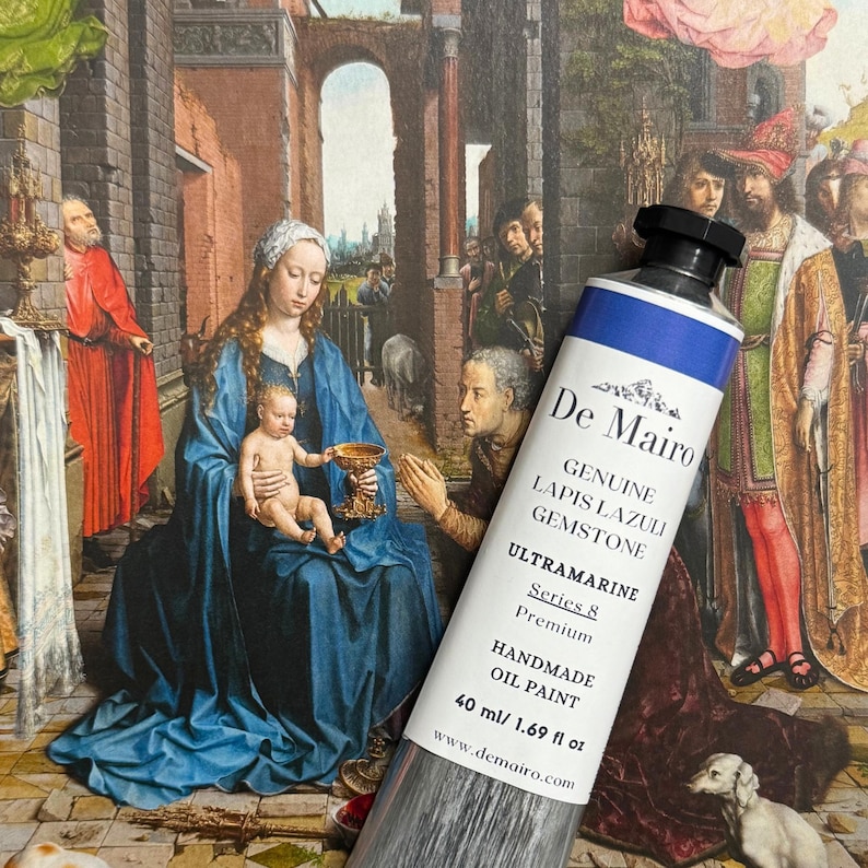 May include: A tube of De Mairo Ultramarine oil paint, 40 ml, with a blue and white label. The tube is set against a backdrop of a Renaissance painting featuring figures in robes and a religious scene.