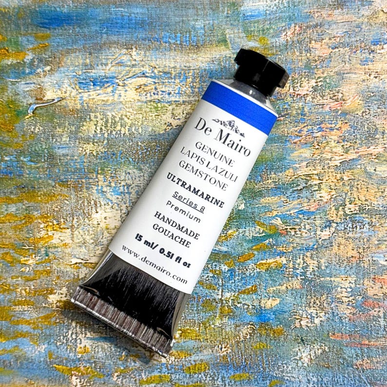 De Mairo lapis lazuli ultramarine blue gouache 15ml tube on textured blue and gold painted surface.