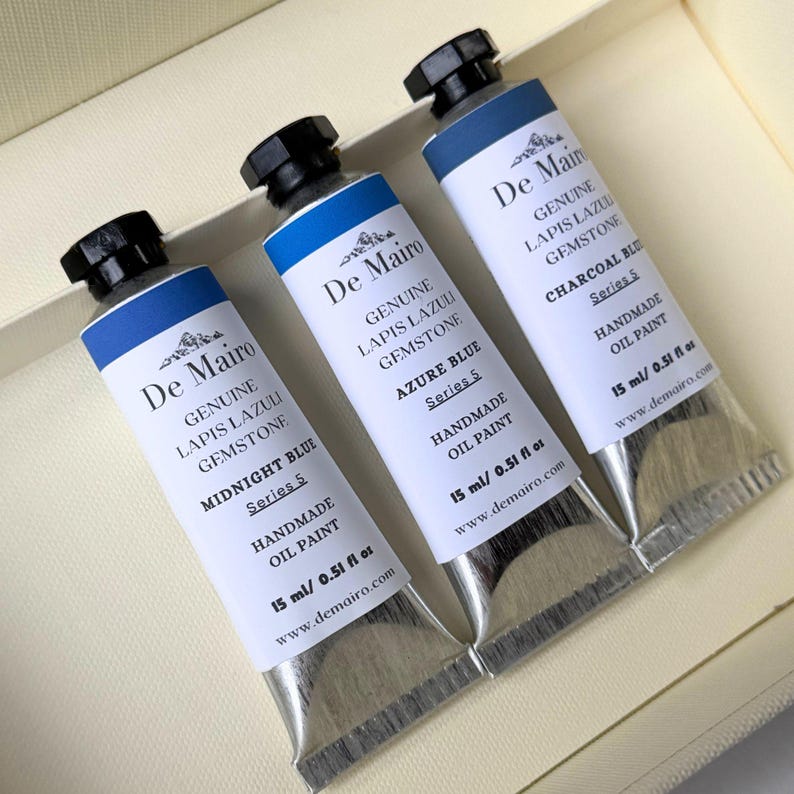 De Mairo Sare Sang Blue oil paint set arranged with Midnight Blue, Azure Blue, and Charcoal Blue tubes.