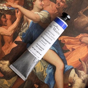 May include: A tube of De Mairo Ultramarine oil paint, labeled "Genuine Lapis Lazuli Gemstone." The tube is silver with a blue and white label, containing 40 ml / 1.69 fl oz of paint. The background features a classical painting.