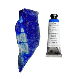 De Mairo ultramarine blue gouache paint tube beside raw lapis lazuli stone for gemstone pigment reference.