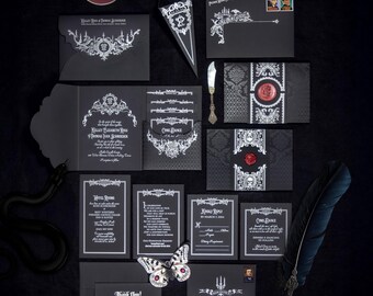May include: A gothic-themed wedding stationery set featuring black paper with intricate white filigree, candelabra, and skull illustrations. The collection includes envelopes, invitation cards, RSVP cards, a thank you note, a wax seal, a quill pen, and a key.