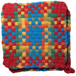 May include: A square, woven potholder in a vibrant patchwork of colors. The design features a grid pattern with squares of red, blue, green, yellow, and orange. The edges are finished with a thick, red border.