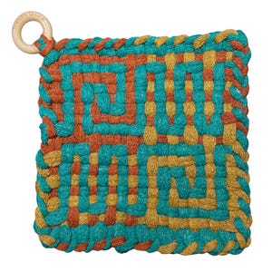 May include: Square, woven hot pad in teal, orange, and gold. The design features a repeating geometric pattern. A wooden ring is attached to one corner. The text "friendly loom" is printed on the wooden ring.