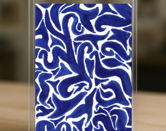 May include: A clear acrylic block displaying a blue and white abstract design. The artwork features flowing, organic shapes in a deep blue hue against a white background. The design is encased in a clear, rectangular frame.