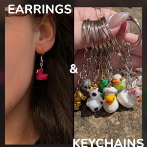 May include: A pink rubber duck earring and a collection of various rubber duck keychains with silver-tone metal rings and chains. The image features the text EARRINGS & KEYCHAINS, showcasing small, colorful duck-shaped charms in different styles.