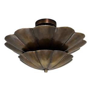 May include: A bronze-colored, scalloped ceiling light fixture. The fixture has a layered design with a circular base and a decorative, petal-like shade. The overall shape is reminiscent of a flower or shell.