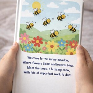 May include: A children's book with a colorful illustration of a sunny meadow. The image features cartoon bees, flowers, a sun, and text that reads, "Welcome to the sunny meadow, Where flowers bloom and breezes blow."