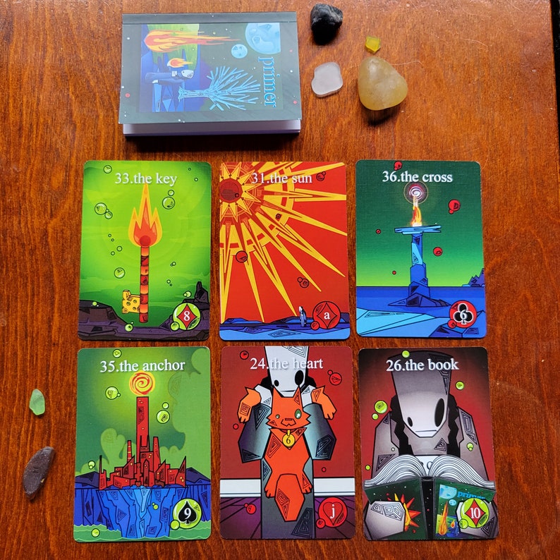 May include: A set of ten tarot cards with colorful illustrations and text. The cards are numbered 31, 33, 35, 36, 24, 26, and include the text "the sun", "the key", "the anchor", "the cross", "the heart", and "the book".