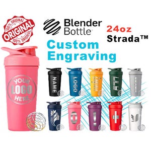 May include: A pink Blender Bottle with a silver logo and the text "YOUR LOGO HERE." The image also shows several other Blender Bottles in various colors, each with a unique design. The bottles are labeled "Custom Engraving" and "24oz Strada."