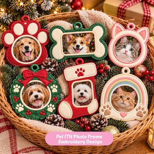 May include: A collection of six embroidered pet photo frames in various shapes including a red paw print, a green bone, a pink cat ear frame, a green wreath, a red stocking, and a rainbow arch, all featuring pet portraits.